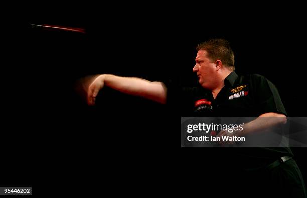 Colin Lloyd of England in action against Denis Ovens of England during the 2010 Ladbrokes.com World Darts Championship Round One at Alexandra Palace...