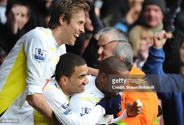 Peter Crouch and Aaron Lennon celebrate with Jermain Defoe of Tottenham Hotspur after Defoe scores his side's second goal during the Barclays Premier...