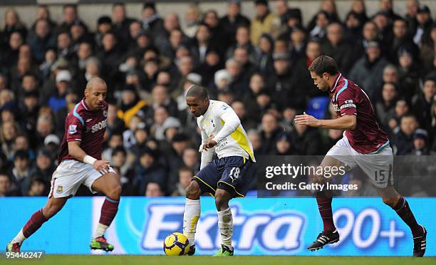 Jermain Defoe of Tottenham Hotspur is closed down by Julien Faubert and Matthew Upson of West Ham during the Barclays Premier League match between...