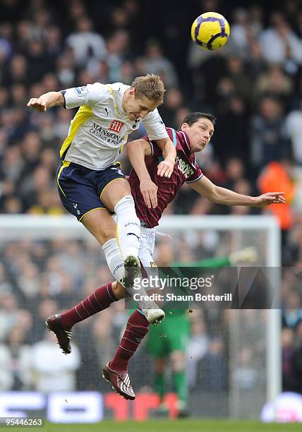 Michael Dawson of Tottenham Hotspur and Guillermo Franco of West Ham battle for the ball during the Barclays Premier League match between Tottenham...