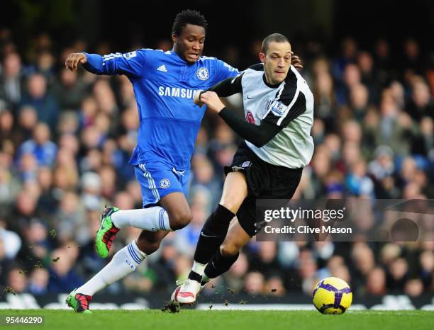 Bobby Zamora of Fulham holds off John Obi Mikel of Chelsea during the Barclays Premier League match between Chelsea and Fulham at Stamford Bridge on...