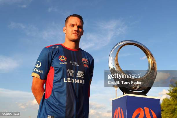 Nigel Boogaard of the Jets poses with the Hyundai A-League Champions Trophy at the Newcastle waterfront during a media opportunity ahead of the 2018...