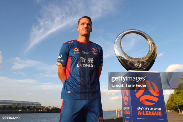 Nigel Boogaard of the Jets poses with the Hyundai A-League Champions Trophy at the Newcastle waterfront during a media opportunity ahead of the 2018...