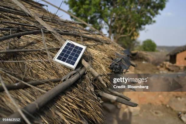 Solar panel sits atop the roof of a house in Kraska village, Rajasthan, India, on Monday, April 16, 2018. The Indian government is trying to relocate...
