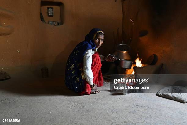 Woman cooks food by fire in a home in Kraska village, Rajasthan, India, on Monday, April 16, 2018. The Indian government is trying to relocate the...