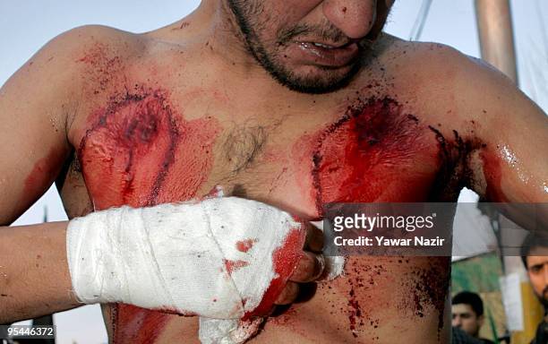 Kashmiri Shiite Muslim clean the wounds after self flagellation during Ashura in Srinagar, India on December 28, 2009. Ashura is a 10 day period of...