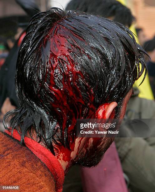 Kashmiri Shiite Muslim is wounded after self flagellation during Ashura in Srinagar, India on December 28, 2009. Ashura is a 10 day period of...