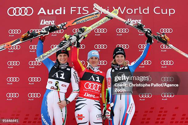 Kathrin Hoelzl of Germany takes 1st place, Manuela Moelgg of Italy takes 2nd place, and Taina Barioz of France takes 3rd place during the Audi FIS...