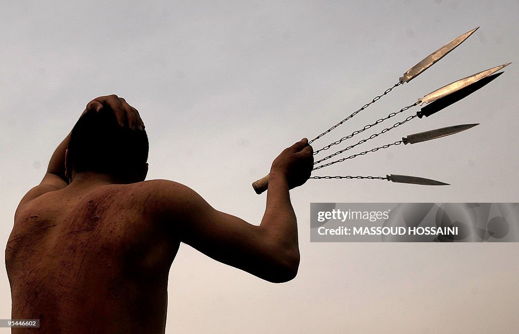 An Afghan Shiite Muslim man beats himsel