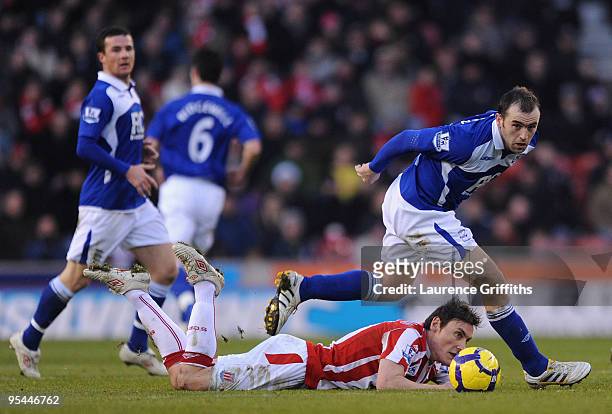 James McFadden of Birmingham breaks past Dean Whitehead of Stoke City during the Barclays Premier League match between Stoke City and Birmingham City...