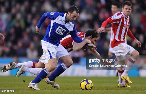 James McFadden of Birmingham breaks past Dean Whitehead of Stoke City during the Barclays Premier League match between Stoke City and Birmingham City...