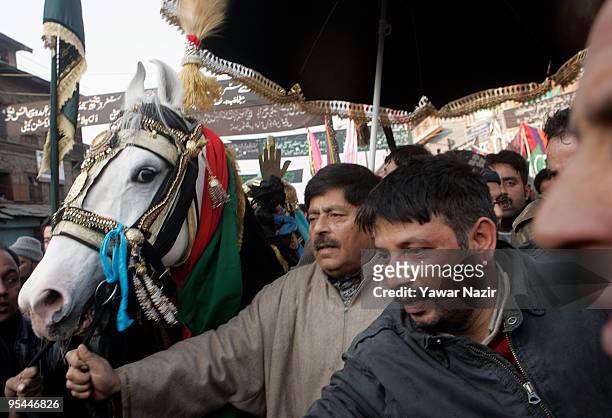 Kashmiri Shiite Muslims walk with a horse during Ashura in Srinagar, India on December 28, 2009. Ashura is a 10 day period of mourning for Imam...