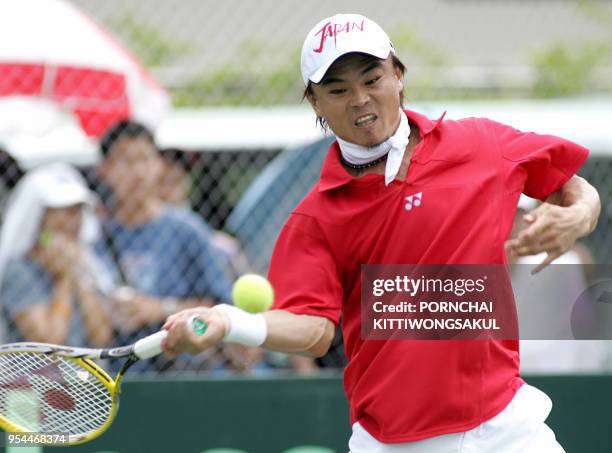 Japanese tennis player Goichi Motomura returns the ball to Paradorn Srichaphan during the Tennis Davis Cup Asia/Oceanis Zone Group 1, second round in...