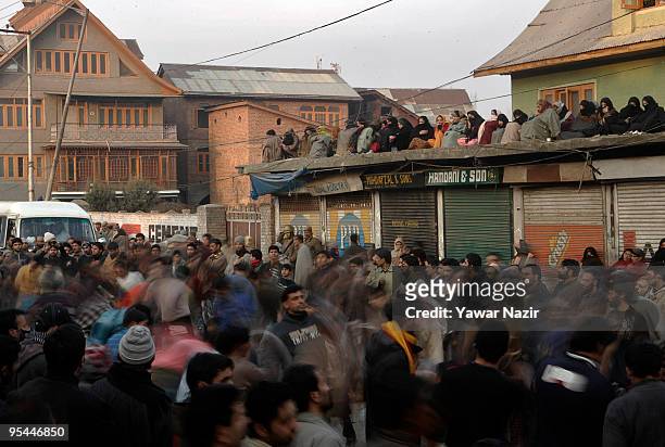 Kashmiri Shiite Muslim women watch on from a rooftop as men self flagelate during Ashura in Srinagar, India on December 28, 2009. Ashura is a 10 day...