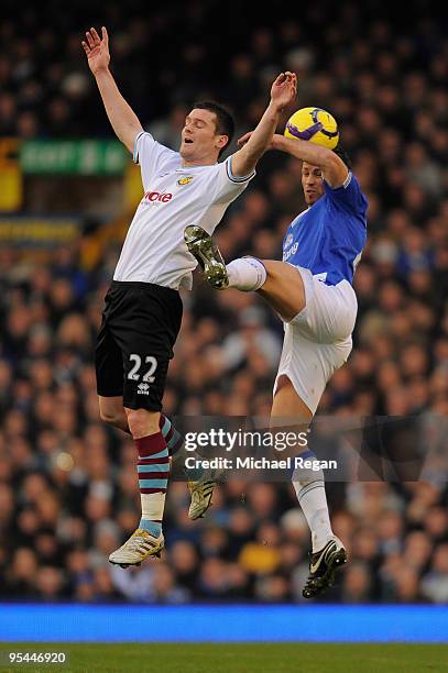 David Nugent of Burnley battles with Lucas Neill of Everton during the Barclays Premier League match between Everton and Burnley at Goodison Park on...