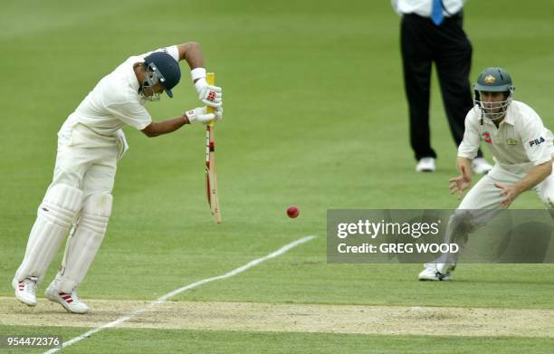 Indian batsman Chopra Akash, plays a shot watched by close in fieldsman Australia's Simon Katich, on day four of the first cricket Test, at the Gabba...