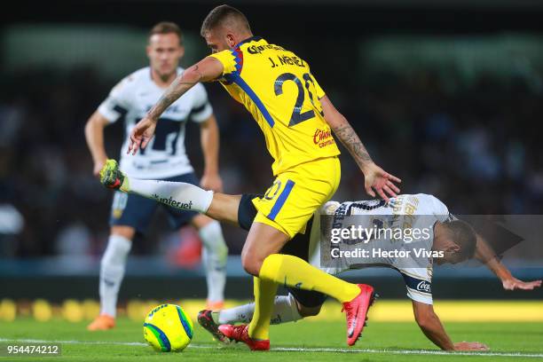 Jeremy Menez of America struggles for the ball with Marcelo Diaz of Pumas during the quarter finals first leg match between Pumas UNAM and America as...
