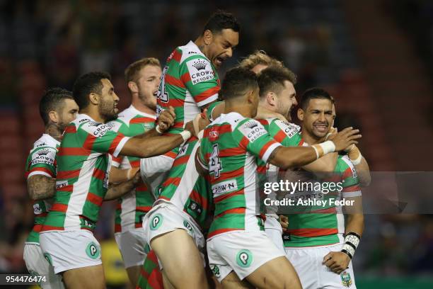 Rabbitohs players celebrate a try from Cody Walker during the round nine NRL match between the Newcastle Knights and the South Sydney Rabbitohs at...