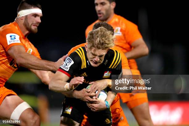 Damian McKenzie of the Chiefs is tackled by Ramiro Moyano of the Jaguares during the round 12 Super Rugby match between the Chiefs and the Jaguares...