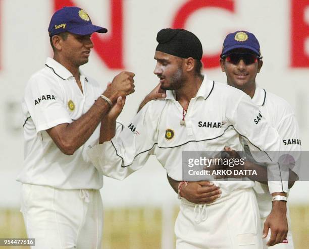 Indian players Venkatesh Prasad and Sadagopan Ramesh congratulate Indian spinner Harbhajan Singh after he took the wicket of Sri Lankan batsman...
