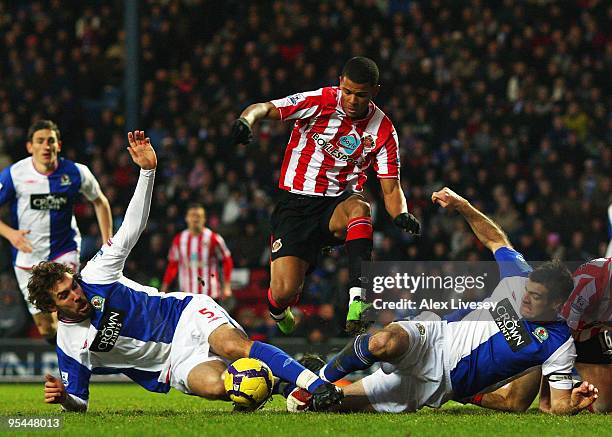 Fraizer Campbell of Sunderland leaps over a challenge from Gael Givet and Ryan Nelsen of Blackburn Rovers during the Barclays Premier League match...