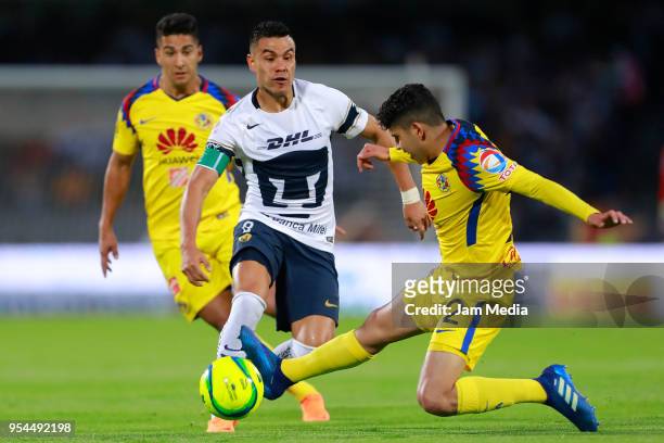 Pablo Barrera of Pumas and Carlos Vargas of America compete for the ball during the quarter finals first leg match between Pumas UNAM and America as...