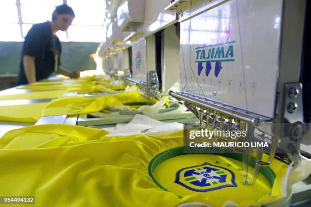 Young girl works on the production line at a factory where the new official jersey of the Brazilian soccer team are made in Sao Paulo, Brazil, 08...