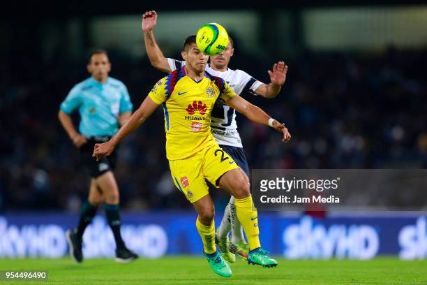 Henry Martin of America and Marcelo Diaz of Pumas compete for the ball during the quarter finals first leg match between Pumas UNAM and America as...