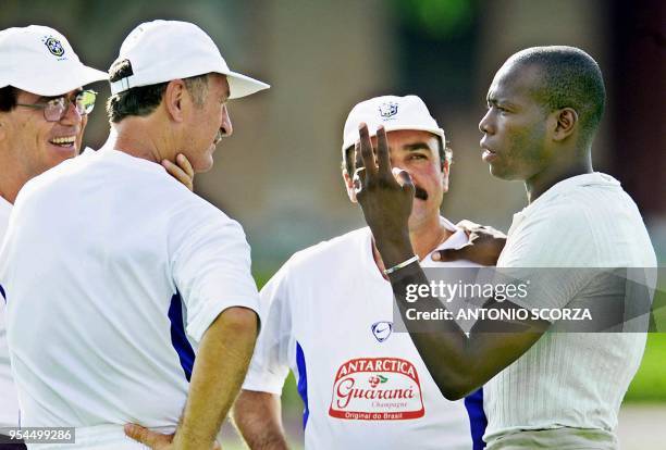 Head coach of the Brazilian soccer team Luis Felipe Scolari speaks with Colombian soccer star Faustino Asprilla , who is accompanied by supervisor...