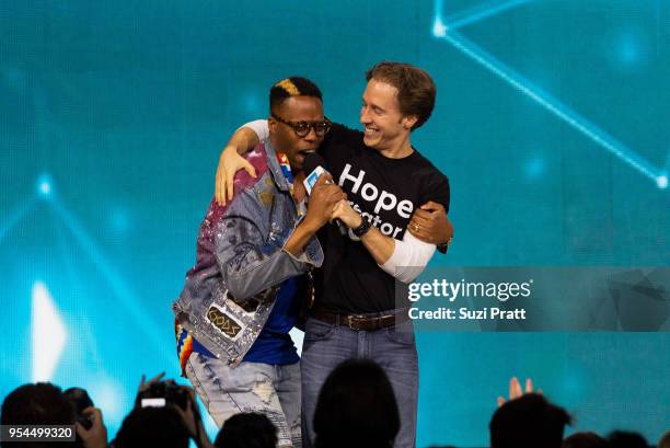 Kardinal Offishall and Craig Kielburger speak at WE Day at Key Arena on May 3, 2018 in Seattle, Washington.