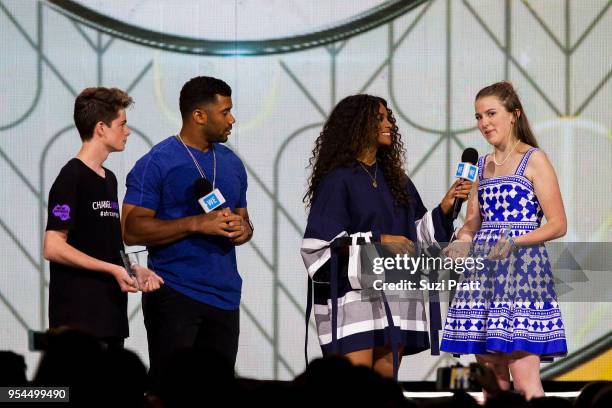 Seattle Seahawks quarterback Russell Wilson and singer Ciara present awards to students at WE Day at Key Arena on May 3, 2018 in Seattle, Washington.
