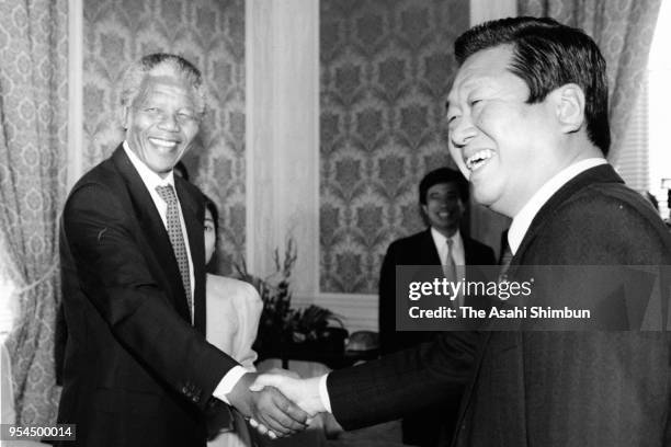 African National Congress Vice President Nelson Mandela shake hands with Liberal Democratic Party secretary general Ichiro Ozawa prior to their...