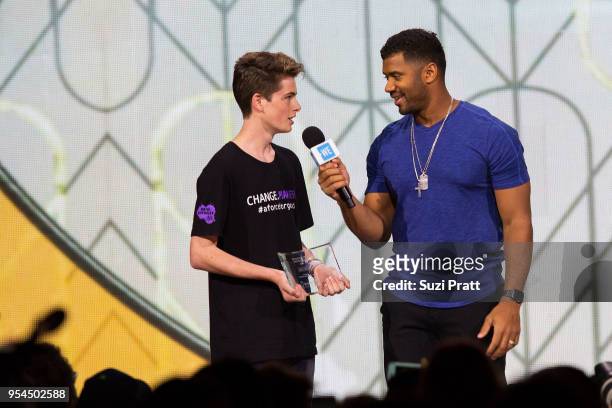 Seattle Seahawks quarterback Russell Wilson speaks with a student at WE Day at Key Arena on May 3, 2018 in Seattle, Washington.