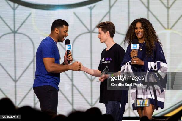 Seattle Seahawks quarterback Russell Wilson and singer Ciara present awards to students at WE Day at Key Arena on May 3, 2018 in Seattle, Washington.