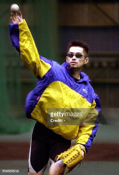 Japanese baseball star Ichiro Suzuki throws a ball during a training session in Kobe 18 November 2000. It was reported 18 November that US Major...