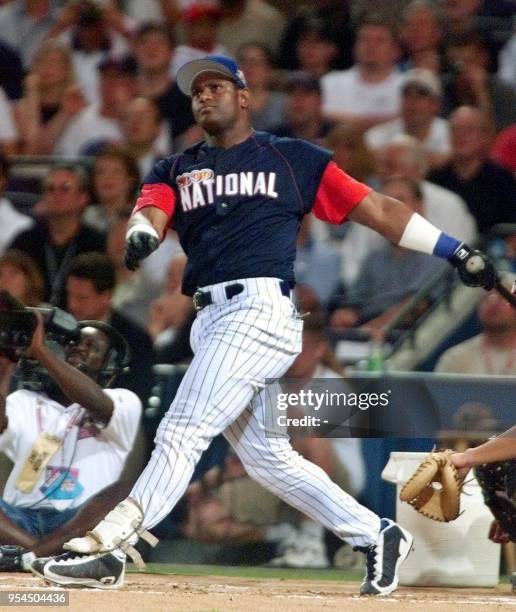 National League All-Star Sammy Sosa of the Chicago Cubs watches his ball fly out of the park during the Home Run Derby 10 July 2000 for the 2000...