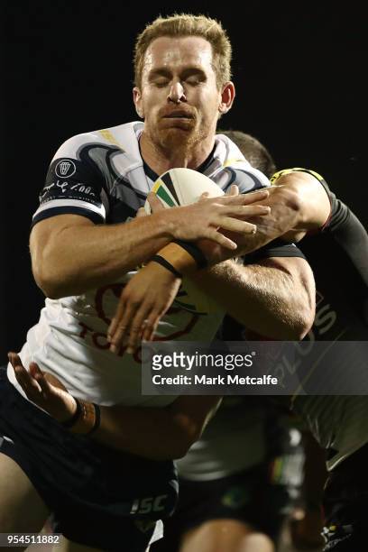 Michael Morgan of the Cowboys breaks a tackle to score a try during the round nine NRL match between the Penrith Panthers and the North Queensland...