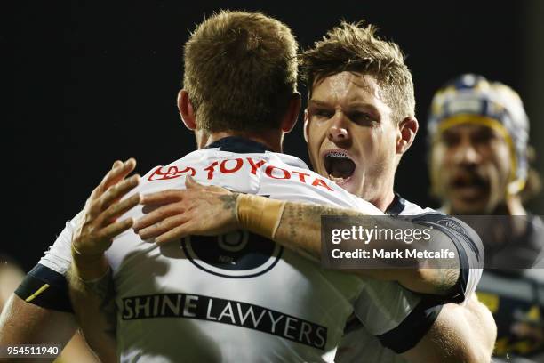 Michael Morgan of the Cowboys celebrates scoring a try with team mates during the round nine NRL match between the Penrith Panthers and the North...