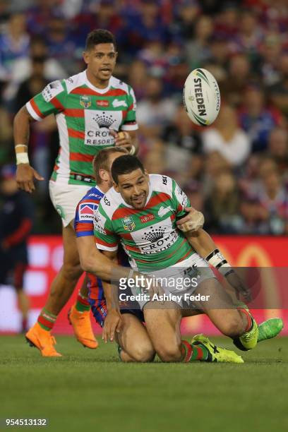 Nathan Ross of the Knights is tackled by Dane Gagai and Cody Walker of the Rabbitohs during the round nine NRL match between the Newcastle Knights...
