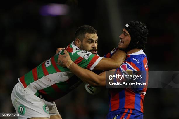 Greg Inglis of the Rabbitohs is tackled by Sione Mata'Utia of the Knihghts during the round nine NRL match between the Newcastle Knights and the...