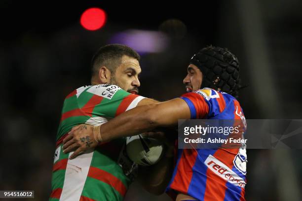 Greg Inglis of the Rabbitohs is tackled by Sione Mata'Utia of the Knihghts during the round nine NRL match between the Newcastle Knights and the...