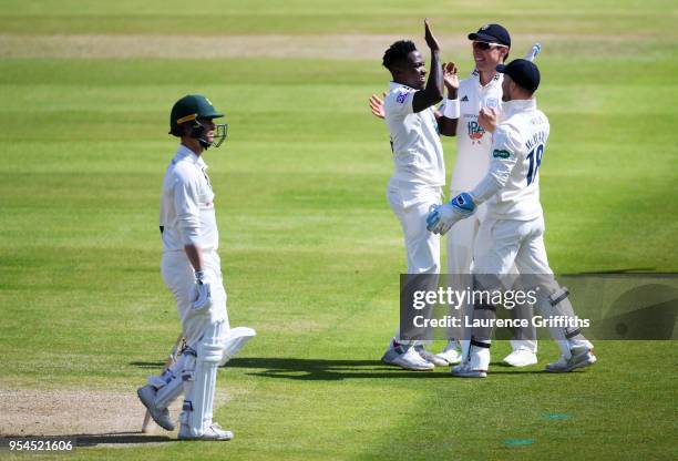 Fidel Edwards of Hampshire County Cricket Club celebrates taking the wicket of Jake Libby of Nottinghamshire County Cricket Club with Joe Weatherly...