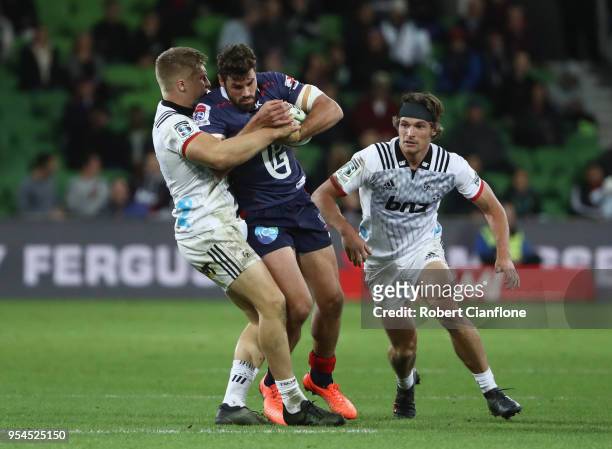 Tom English of the Rebels is challenged by Jack Goodhue of the Crusaders during the round 12 Super Rugby match between the Rebels and the Crusaders...