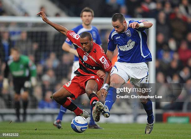 Jay Simpson of QPR battles with Damien Delaney of Ipswich during the Coca-Cola Championship match between Ipswich Town and Queens Park Rangers at...