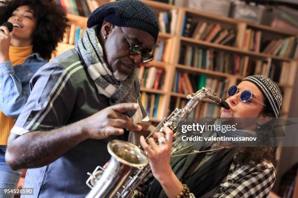 band making rehersal at home - woman in guitar making studio stock pictures, royalty-free photos & images