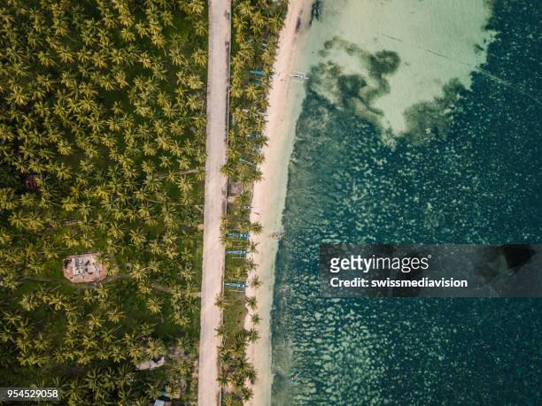 aerial view of tropical beach and street nearby in the philippines - mindanao stock pictures, royalty-free photos & images
