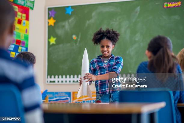 girl showing her rocket - model rocket stock pictures, royalty-free photos & images
