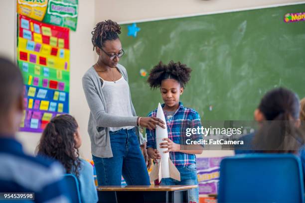 teacher helping student - model rocket stock pictures, royalty-free photos & images