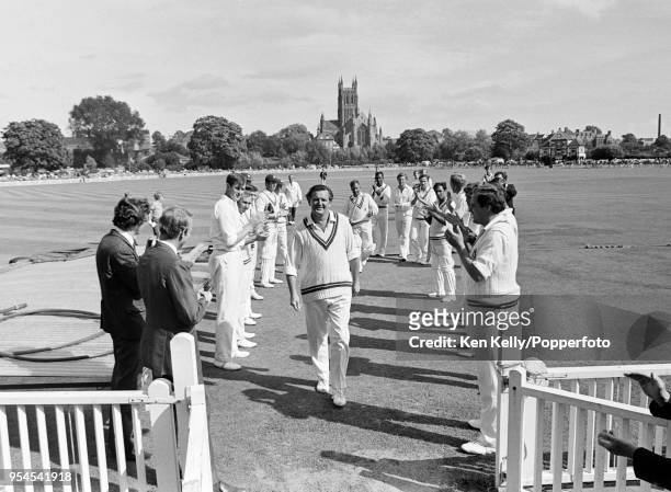 Tom Graveney of Worcestershire gets a guard of honour from both teams at the end of his last innings in the field in County Championship cricket,...