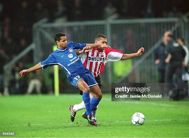 Ratinho of Kaiserslautern holds off Wilfred Bouma of PSV Eindhoven during the UEFA Cup Quarter Finals second leg match played at the Philips Stadion,...